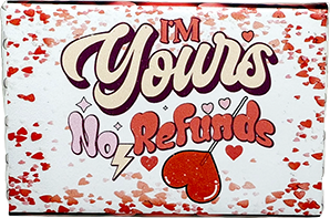 A square white product box with a red and pink heart confetti pattern, featuring the text 'I'M Yours No Refund' in stylized lettering with a red heart and lightning bolt graphic.