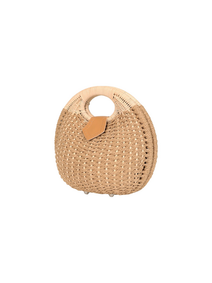 Round woven bag with a leather handle on a white background