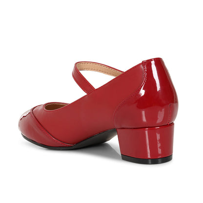 A red patent leather Mary Jane shoe with a low block heel, shown from a side-rear angle on a white background.