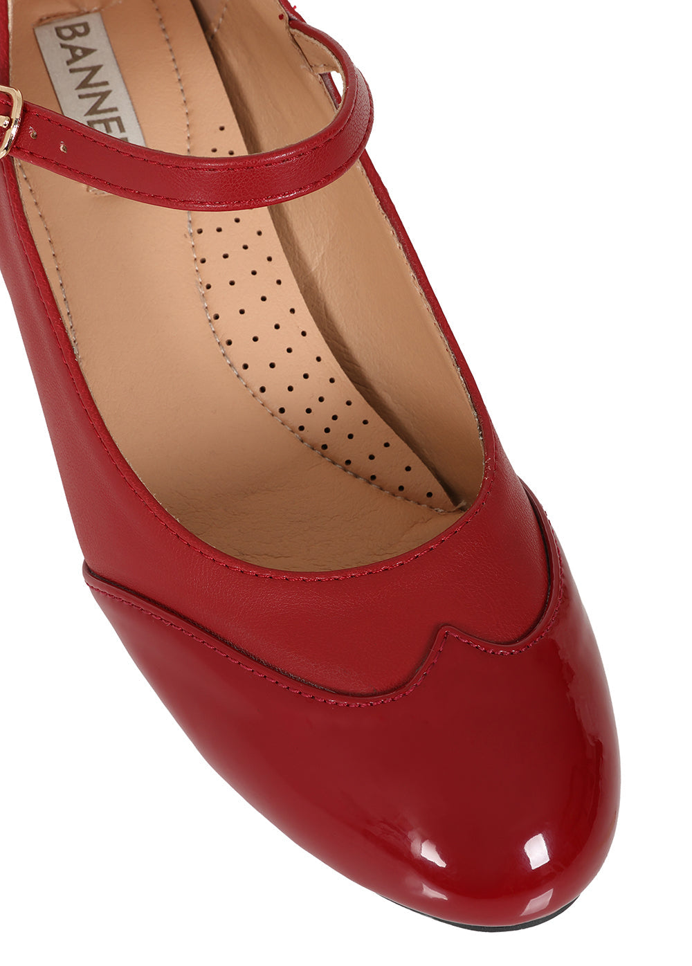 A close-up of a red patent leather Mary Jane shoe with a T-strap and ankle buckle, shown on a white background. The brand name 'BANNISTER' is visible on the insole.