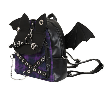 Black faux-leather backpack with bat wings, a bat head detail, and a purple plaid patterned panel on the front, shown on a white background.