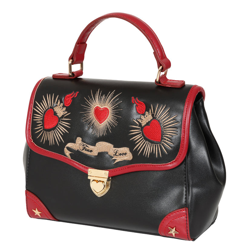 Black handbag with red accents and heart designs on a white background