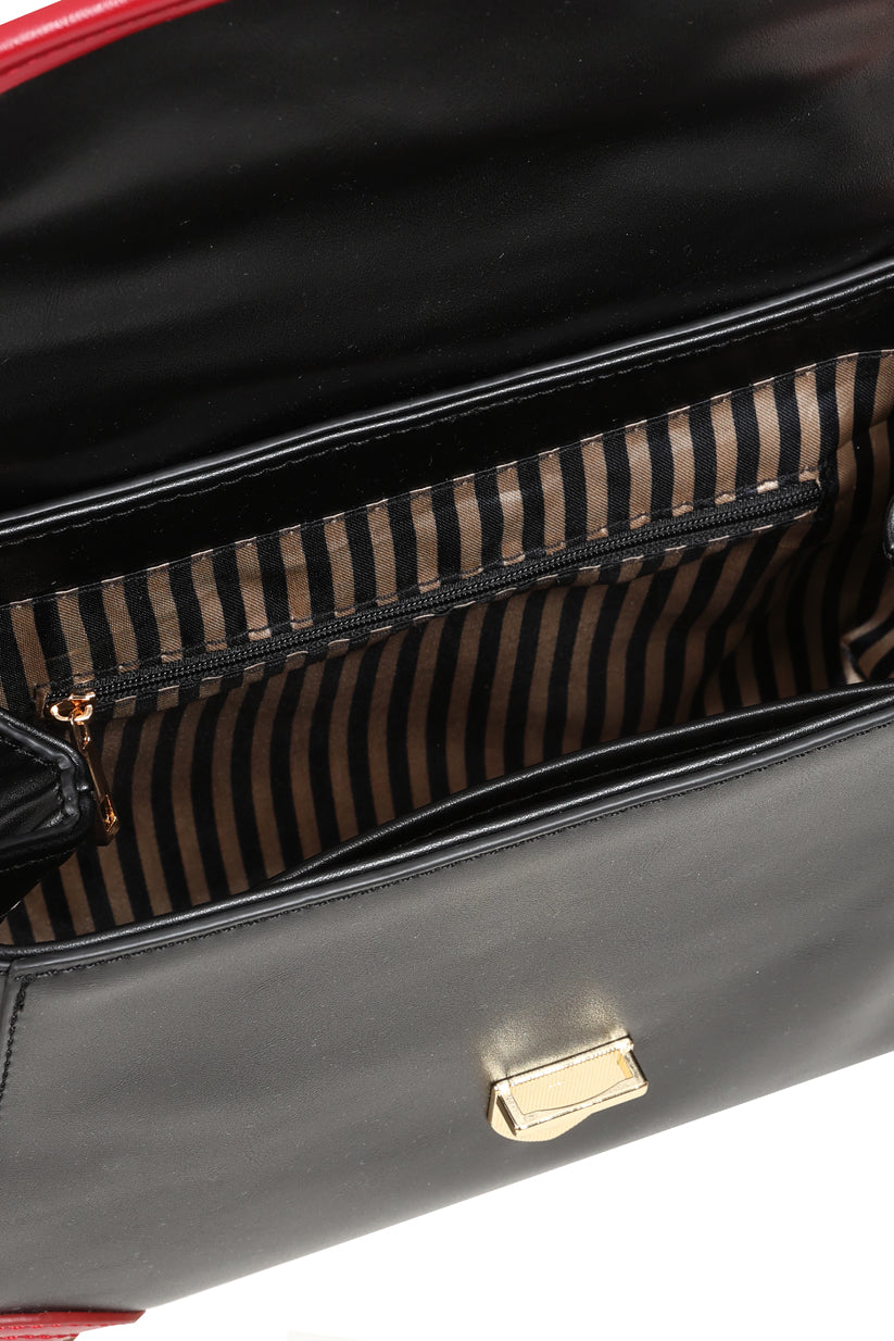 Close-up of a black leather handbag interior showing a striped brown and black zippered pocket with gold-tone hardware.