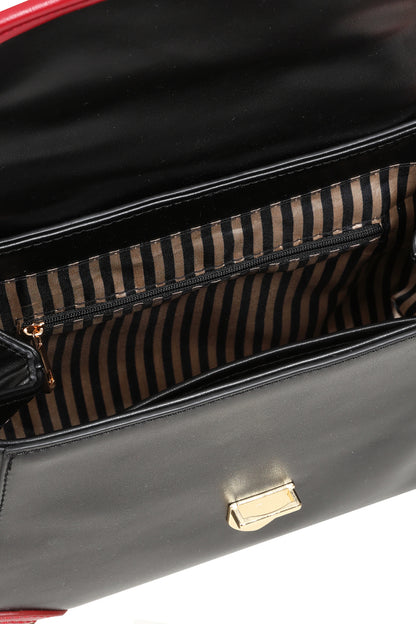 Close-up of a black leather handbag interior showing a striped brown and black zippered pocket with gold-tone hardware.