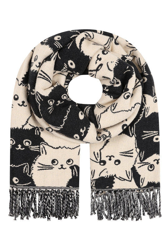 A cream-colored knit scarf with a black cat pattern and fringed ends, displayed on a solid white background.