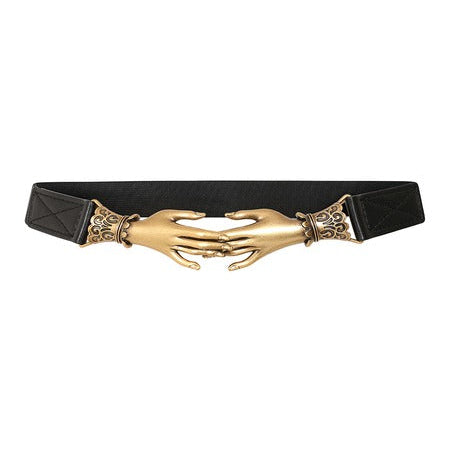 A black belt featuring a large gold-toned metal buckle shaped like two hands clasped together, with ornate decorative details on either side, shown against a plain white background.