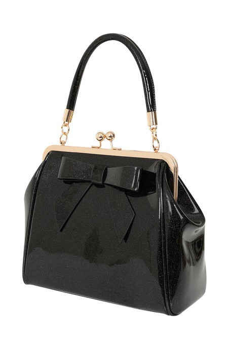 Black patent leather handbag with a bow detail on a white background