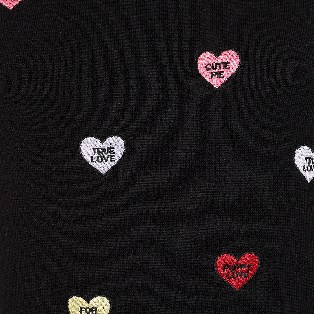 Black knit fabric with scattered heart-shaped candy cane motifs in red, pink, white, and gold, each containing text like 'CUTE PIE TRUE LOVE' or 'FOR YOU EVER'.