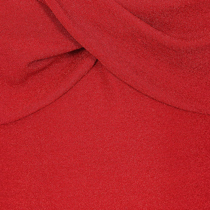 A close-up of a vibrant red knit fabric with a soft draped fold at the top.