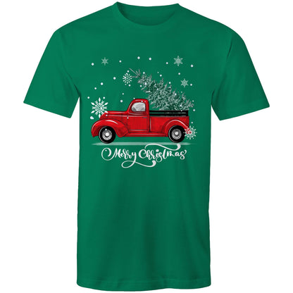 A green crewneck t-shirt featuring a festive graphic of a vintage red pickup truck carrying a Christmas tree, surrounded by white snowflakes and the text 'Merry Christmas' in white script.