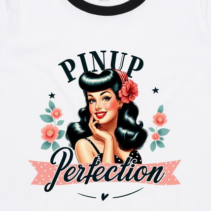 White ringer t-shirt featuring a retro pin-up girl graphic with the text 'PINUP Perfection' in black and pink script, surrounded by pink flowers and green leaves.