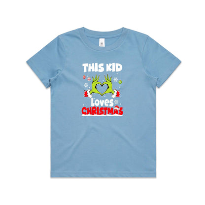 A close-up of a green Christmas t-shirt featuring a graphic of the Grinch's hands forming a heart, with the text 'THIS KID Loves CHRISTMAS' in white and red.