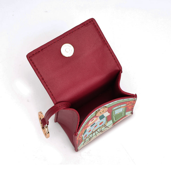 A small red leather card holder wallet with a gold snap button closure and a decorative illustrated paper insert, shown open on a white background.