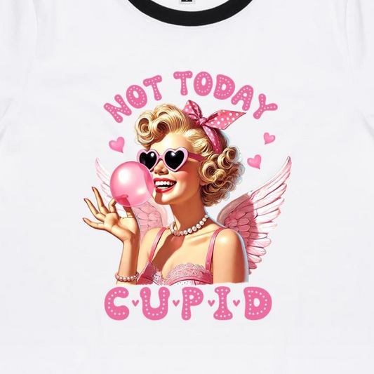 A white women's ringer tee with the text 'Not Today Cupid' and a graphic of a woman holding a pink heart.