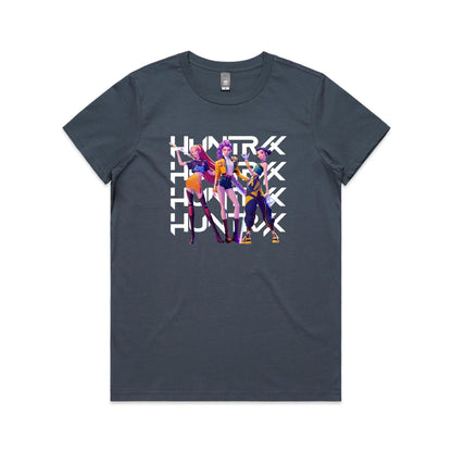 A close-up of a t-shirt featuring a graphic print of three stylized female characters in colorful outfits, overlaid with the word 'HUNTER' repeated vertically in bold white letters.