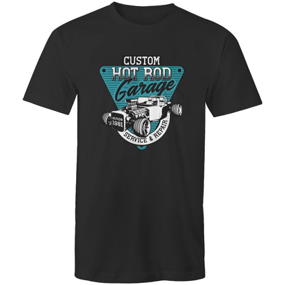 A light blue t-shirt featuring a large graphic print on the chest. The graphic is a teal and black triangular badge with the text 'CUSTOM HOT ROD Garage' and 'SERVICE & REPAIR since 1981', surrounding an illustration of a classic hot rod car with an exposed engine elements.