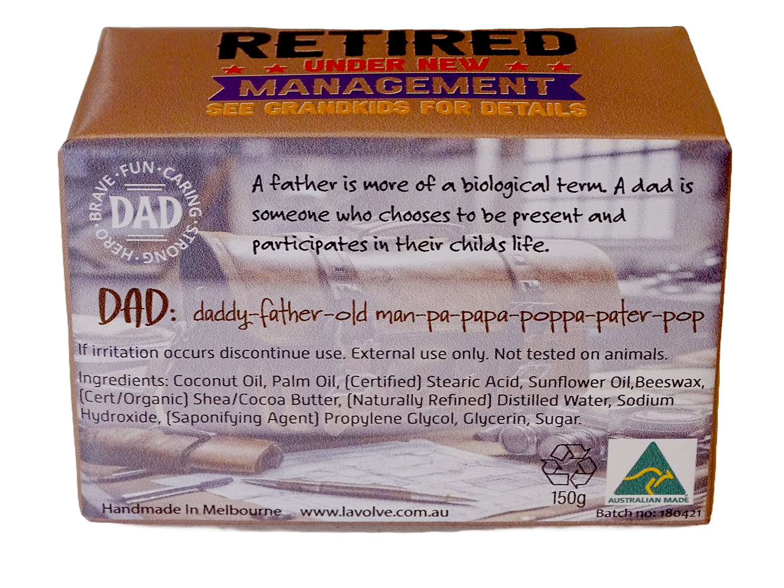 A rectangular cardboard product box for Lavolve 'Retired Under New Management' DAD soap, featuring a brown top and side panels with white and red text, and a faded photo of a father and child on the front.
