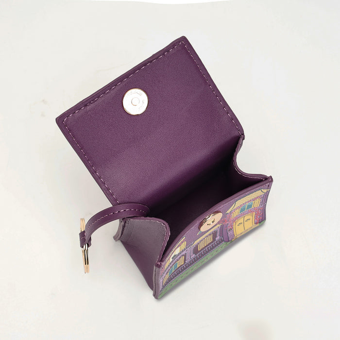 A purple leather card holder wallet with a snap button closure and a colorful illustrated pattern on the inner flap, shown open on a white background.
