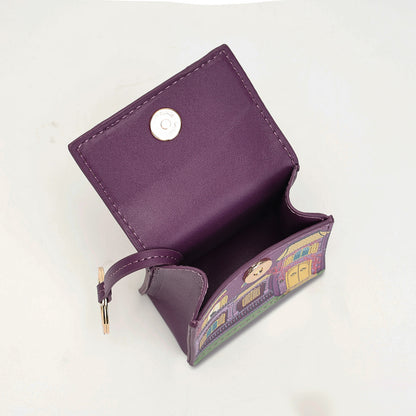 A purple leather card holder wallet with a snap button closure and a colorful illustrated pattern on the inner flap, shown open on a white background.