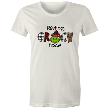 White crewneck t-shirt featuring a graphic print of the Grinch wearing a red and black plaid Santa hat, with the text 'Resting GRCH face' in black.