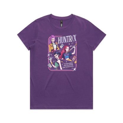 t-shirt featuring a colorful graphic print of three anime-style female characters with pink, purple, and black hair, holding snacks and a sword, with the text 'HUNTR/X' and 'I'm done hiding Now I'm shining Like I'm born to be.