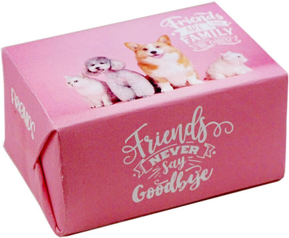 A pink rectangular gift box with printed dog and cat illustrations and the phrase 'Friends Never Say Goodbye' on the front, photographed on a plain white background.