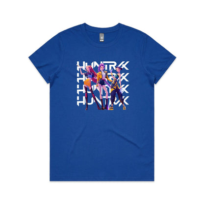 A close-up of a t-shirt featuring a graphic print of three stylized female characters in colorful outfits, overlaid with the word 'HUNTER' repeated vertically in bold white letters.
