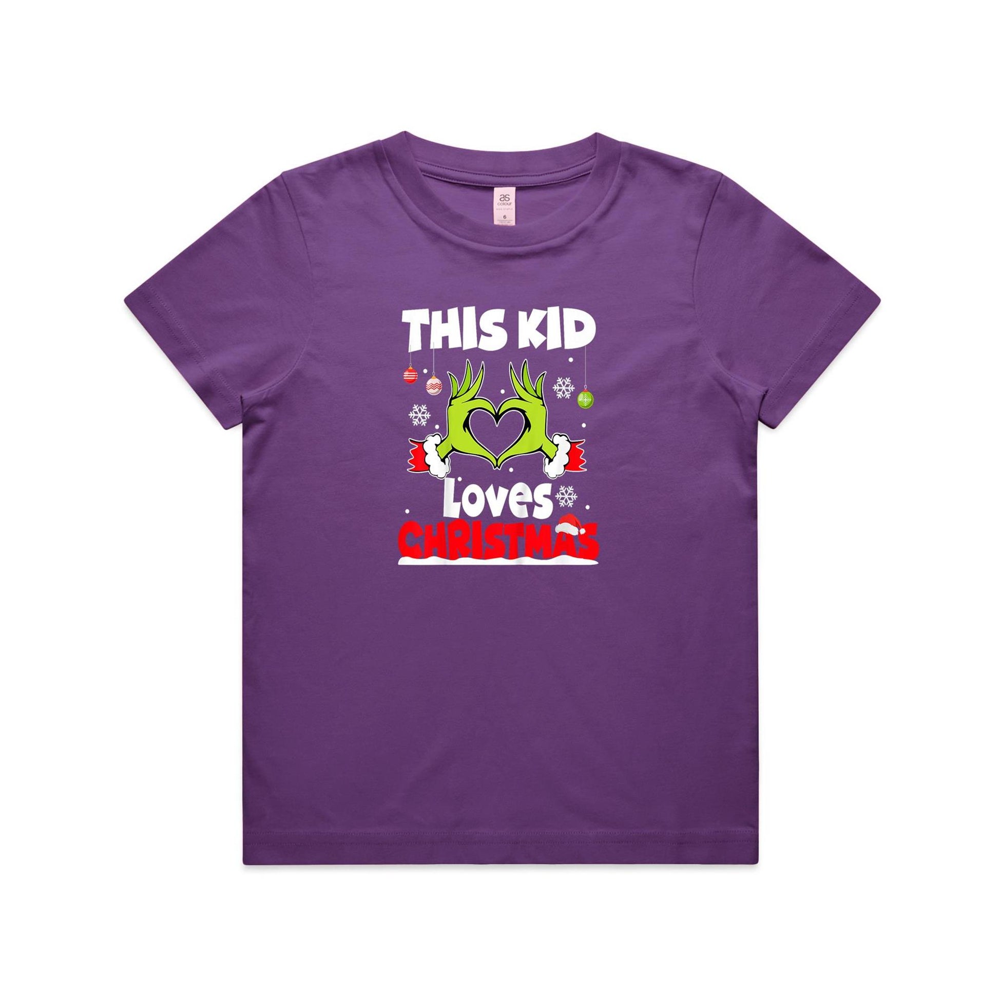 A close-up of a green Christmas t-shirt featuring a graphic of the Grinch's hands forming a heart, with the text 'THIS KID Loves CHRISTMAS' in white and red.