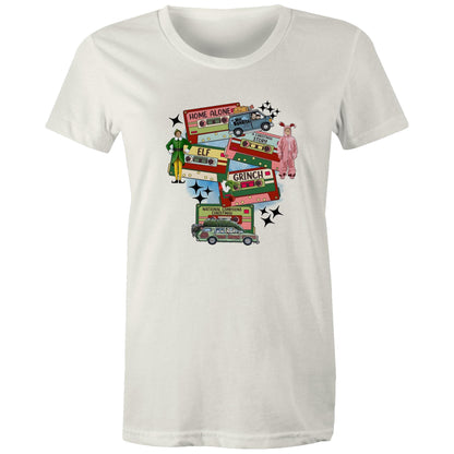 A graphic print on a light beige fabric featuring retro cassette tapes labeled 'Home Alone', 'Elf', 'The Grinch', 'National Lampoons Christmas', and 'A Christmas Story', with illustrated characters and black starbursts.