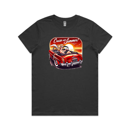 A graphic print on a black t-shirt featuring a retro-style illustration of a blonde woman in a red convertible car at sunset, with the text 'Cruise into Summer!' above.