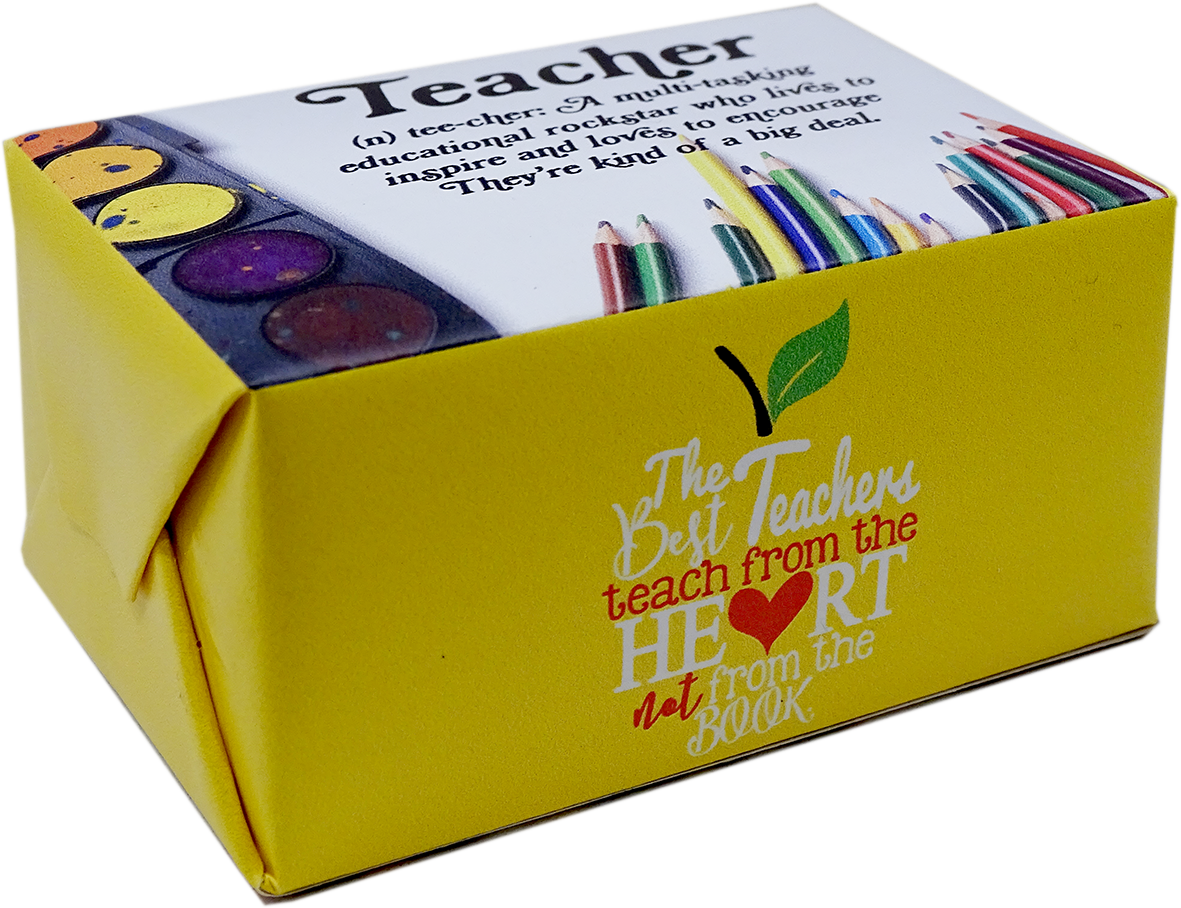 A yellow gift box for a Teacher-themed book, featuring colorful illustrations of colored pencils, paint palettes, and a green leaf. The front of the box displays the quote 'The Teachers teach from the HEART not from the BOOK' in stylized text.