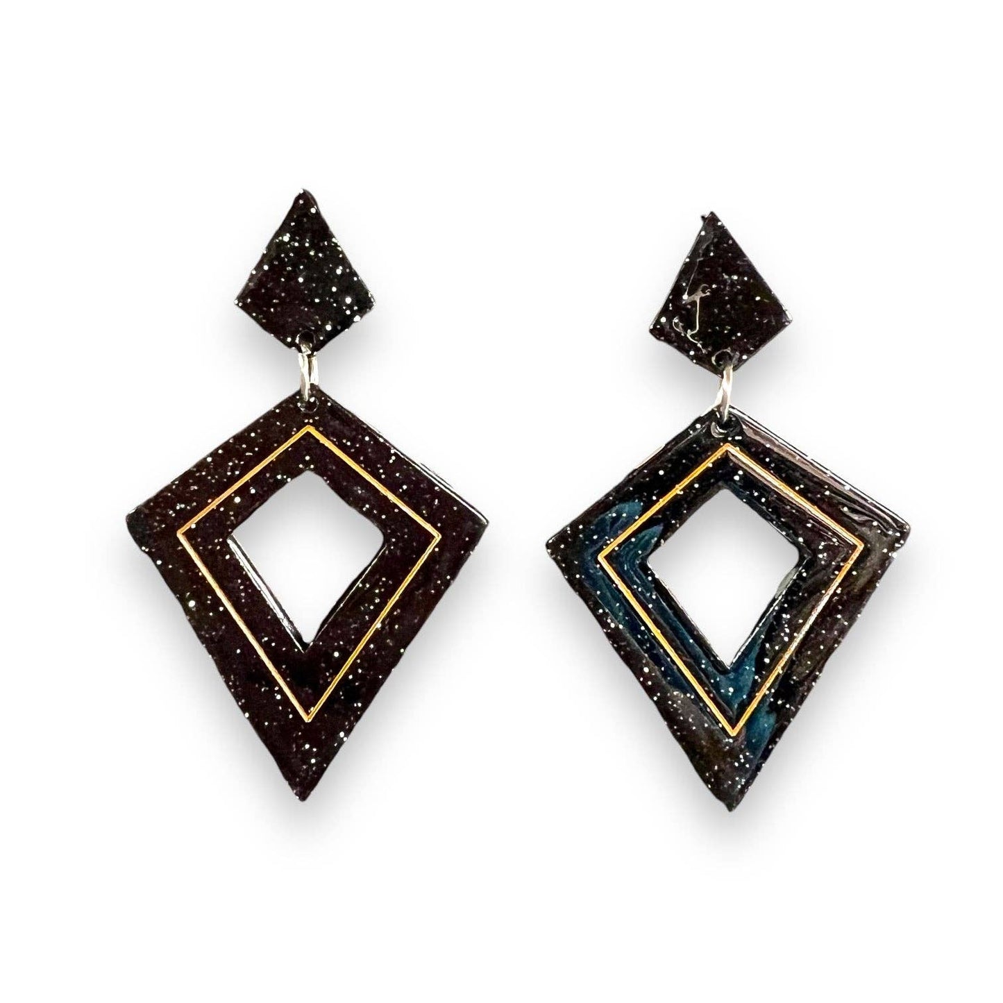 Pair of geometric earrings with a black and gold design on a white background