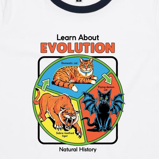 A white ringer t-shirt featuring a colorful educational graphic about evolution. The graphic shows a domestic cat, a flying demon cat, and a saber-toothed tiger arranged in a circle with the text 'Learn About EVOLUTION Natural History'.