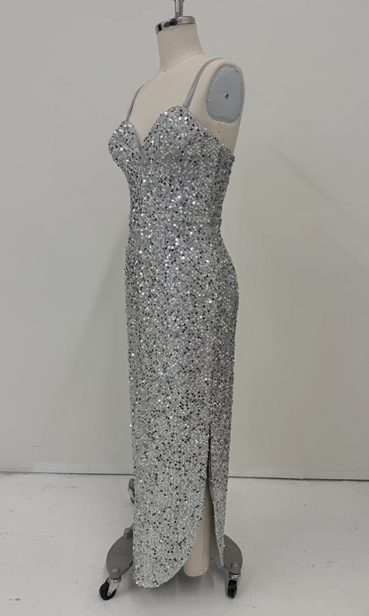 A floor-length silver sequin gown displayed on a dress form mannequin against a plain light gray studio background.