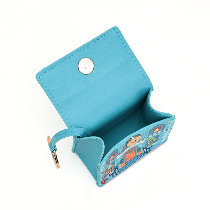 A small turquoise blue card holder wallet with a snap button closure and a colorful cartoon illustration on the front, shown open on a white background.
