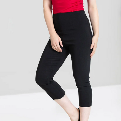 Person wearing a red off-shoulder top and black capri pants on a white background