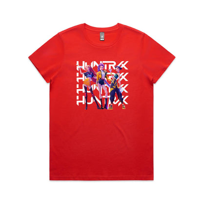 A close-up of a t-shirt featuring a graphic print of three stylized female characters in colorful outfits, overlaid with the word 'HUNTER' repeated vertically in bold white letters.