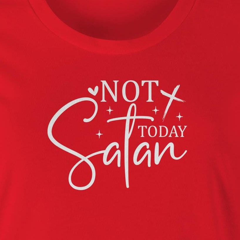 A close-up of a bright red t-shirt featuring a white graphic print that reads 'NOT TODAY Satan' with decorative script and star accents.