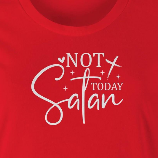 A close-up of a bright red t-shirt featuring a white graphic print that reads 'NOT TODAY Satan' with decorative script and star accents.