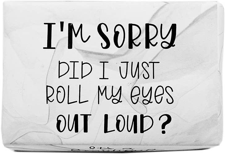 A rectangular white towel or cloth with black printed text that reads, 'I'M SORRY DID I JUST ROLL MY EYES OUT LOUD?' on a plain white background.