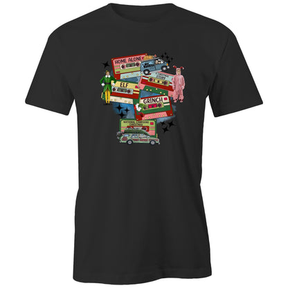A dark gray graphic print featuring Christmas-themed cassette tapes and characters from The Grinch movie, including a green and yellow Elf, a pink Grinch in a onesie, and a green station wagon with a Christmas tree. Text includes 'Home Alone', 'Elf', 'Grinch', and 'National Lampoons Christmas'.