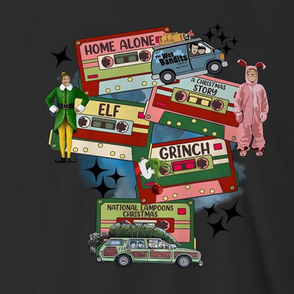 A dark gray graphic print featuring Christmas-themed cassette tapes and characters from The Grinch movie, including a green and yellow Elf, a pink Grinch in a onesie, and a green station wagon with a Christmas tree. Text includes 'Home Alone', 'Elf', 'Grinch', and 'National Lampoons Christmas'.