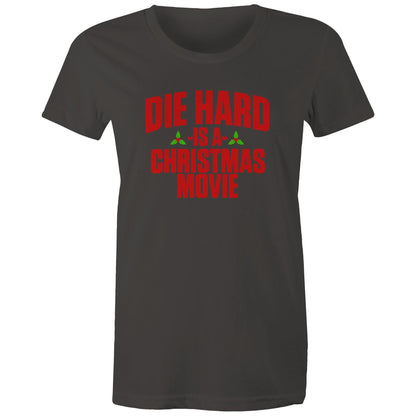 A black women's t-shirt with the text 'DIE HARD IS A CHRISTMAS MOVIE' printed in red and white.