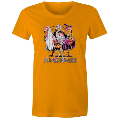 A white t-shirt featuring a colorful graphic of three cartoon flamingos dressed in Halloween costumes. One flamingo wears a white ghost and lantern, another is wrapped in bandages and holds a pumpkin bucket, and the third wears a purple witch hat and cape while holding a jack-o'-lantern.