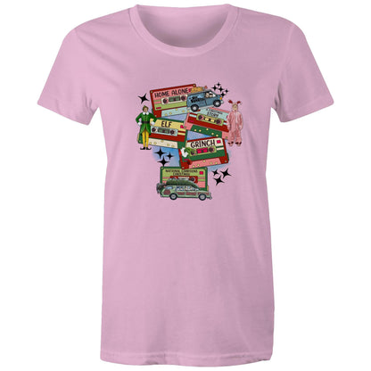 A graphic print on a light beige fabric featuring retro cassette tapes labeled 'Home Alone', 'Elf', 'The Grinch', 'National Lampoons Christmas', and 'A Christmas Story', with illustrated characters and black starbursts.
