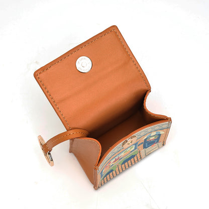 A small tan leather wallet shown open on a white background, featuring a silver snap button closure on the inside flap and a decorative printed exterior panel with a colorful illustration.
