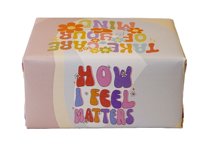 A square product box with a retro 1960s-style design, featuring the text 'HOW I FEEL MATTERS' in colorful bubble letters on a light pink and white background with wavy stripes.