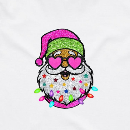 A festive embroidered Santa face design on a white fabric background. The Santa figure has a glittery pink Santa hat, heart-shaped pink glasses, a white beard decorated with colorful stars, and colorful Christmas lights around the bottom.