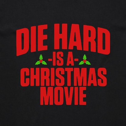 A black t-shirt with the text 'DIE HARD IS A CHRISTMAS MOVIE' printed in red and white.