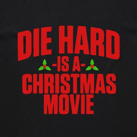 A black t-shirt with the text 'DIE HARD IS A CHRISTMAS MOVIE' printed in red and white.